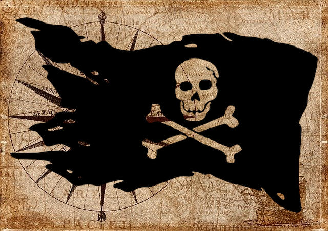 Una ajada bandera pirata ondea sobre lo que parece ser un mapa